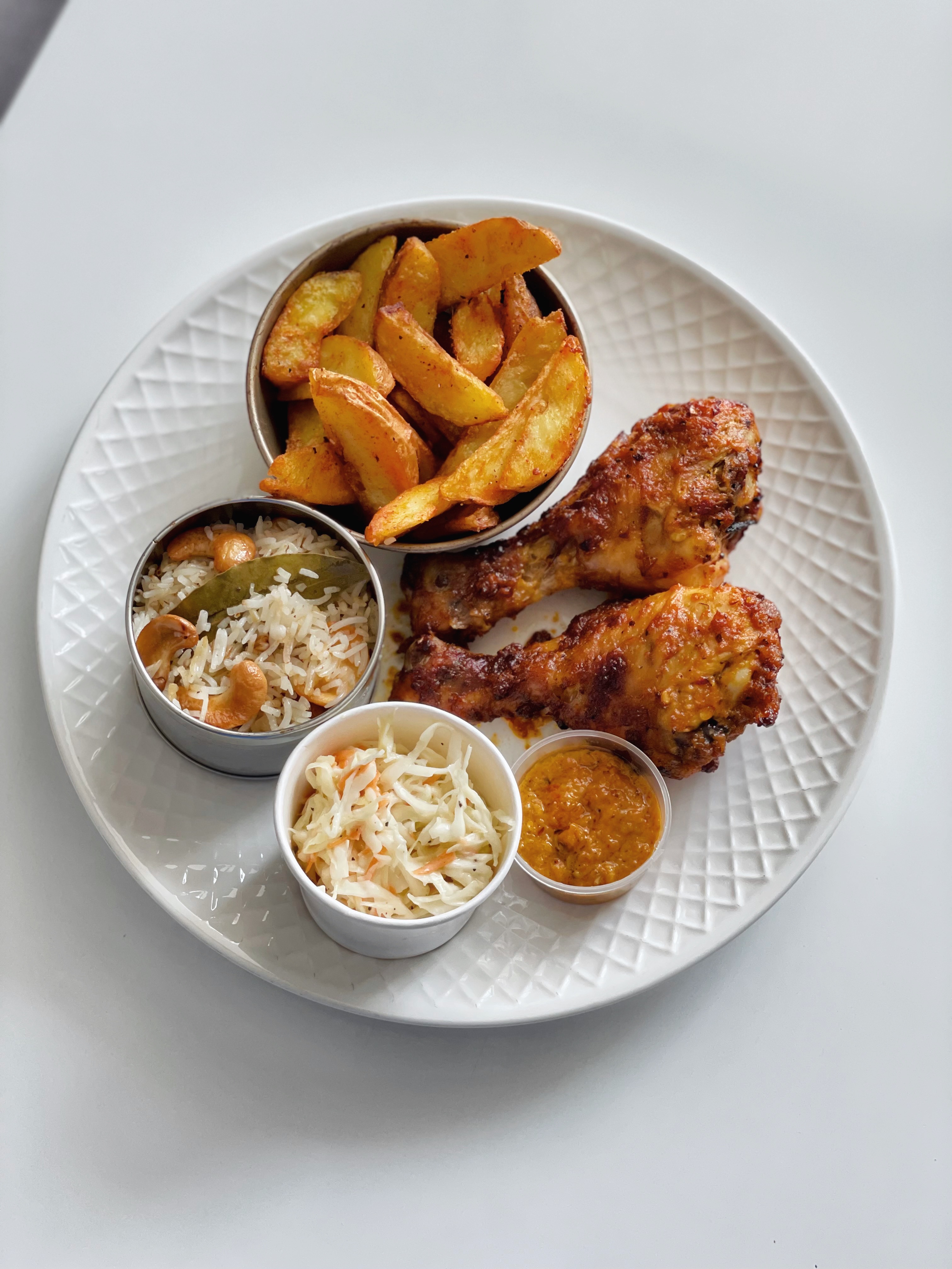 Peri Peri drumsticks with wedges, coleslaw, pilau rice and peri peri sauce